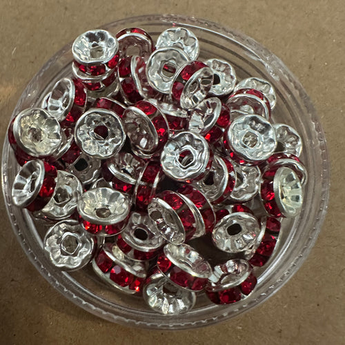 50 red and silver rondelle spacers.