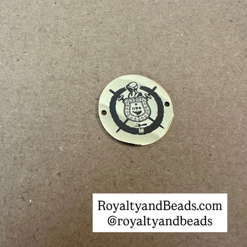 Gold Omega shield charm.