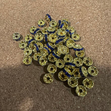 Load image into Gallery viewer, 50 blue and gold rondelle spacers.