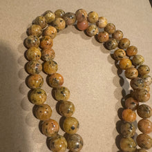 Load image into Gallery viewer, Orange and black beads.