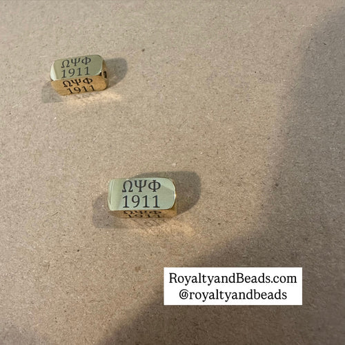 Omega Psi Phi 1911 charm.