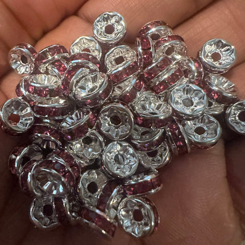 50 pink and silver rondelle spacers.