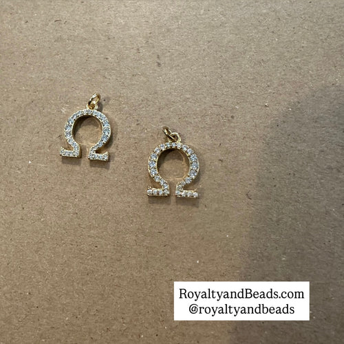 2 Gold pave Omega charms.