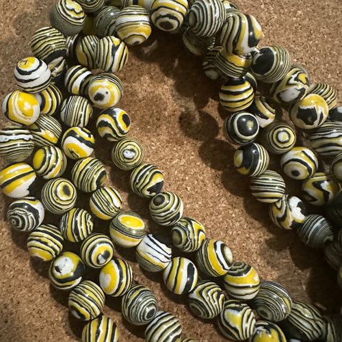 Yellow and black swirl beads.