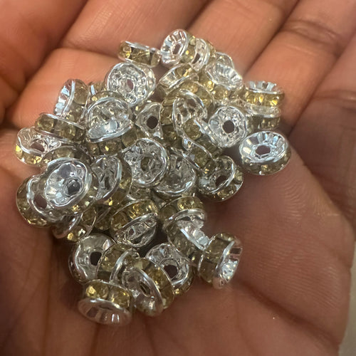 50 yellow and silver rondelle spacers.