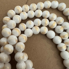 Load image into Gallery viewer, White and gold beads.