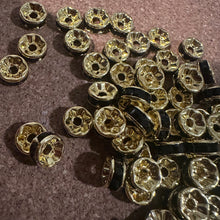 Load image into Gallery viewer, 50 black and gold rondelle spacers.