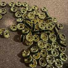 Load image into Gallery viewer, 50 black and gold rondelle spacers.