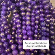 Load image into Gallery viewer, Purple and gold beads.