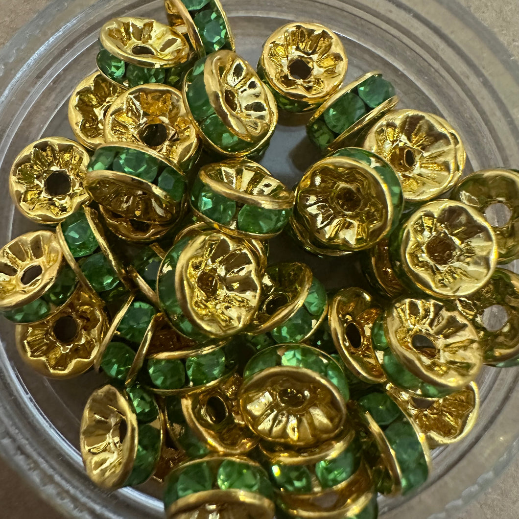 50 green and gold rondelle spacers.
