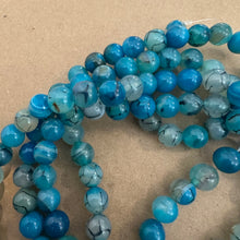 Load image into Gallery viewer, Blue and black agate beads.