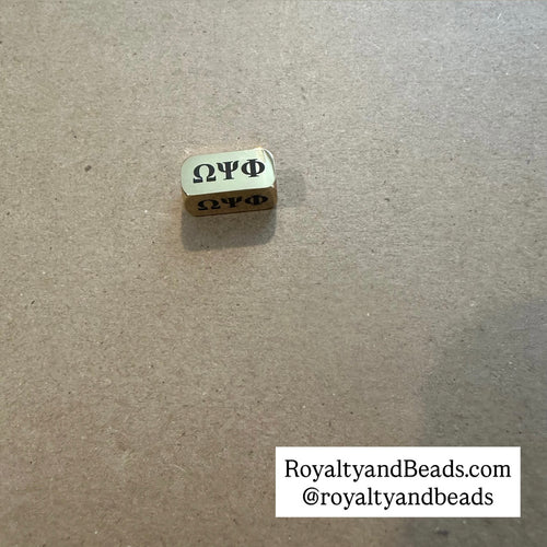 Omega Psi Phi charm. (Gold)