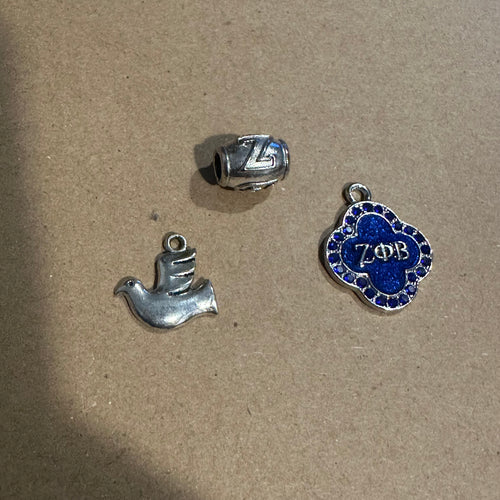 3 silver Zeta charms