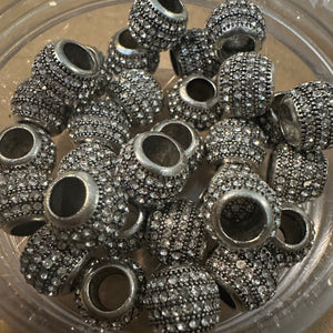 5 silver rhinestone beads.