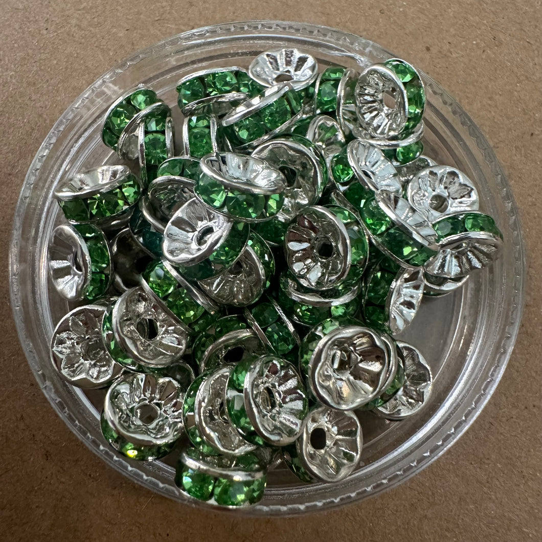 50 green and silver rondelle spacers.