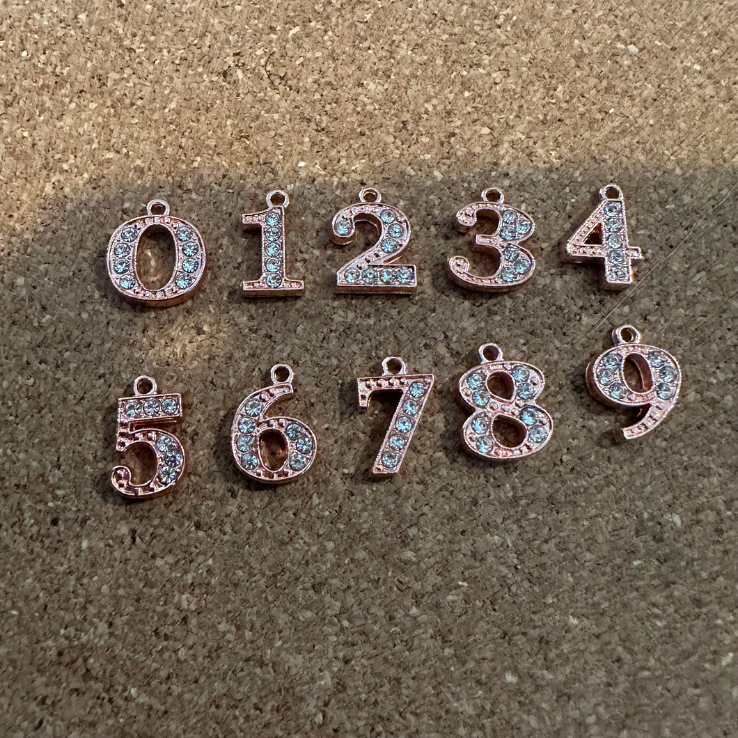 Rose Gold Rhinestone number charm.