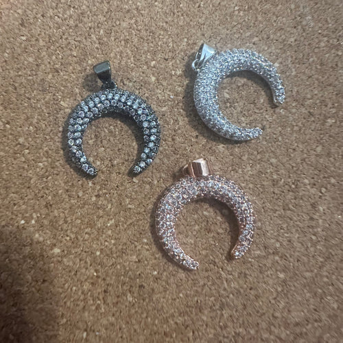 Clear half circle pave charms.