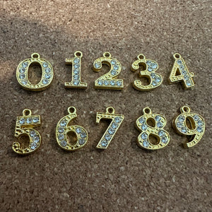 Gold Rhinestone number charm.