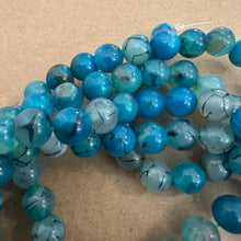 Load image into Gallery viewer, Blue and black agate beads.