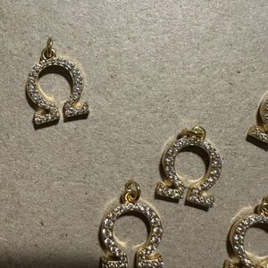 2 Gold pave Omega charms.