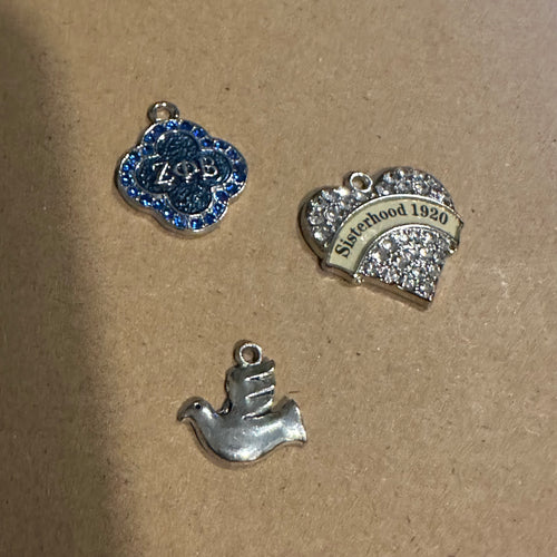 3 silver Zeta charms