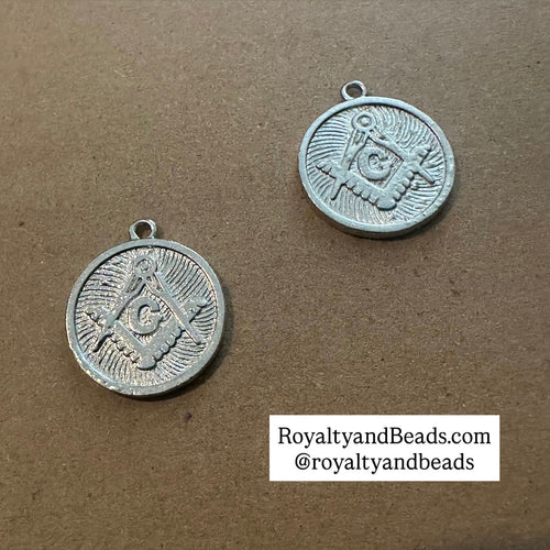 The silver Mason charm.