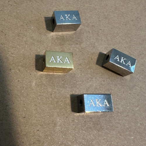 Small AKA block charms.