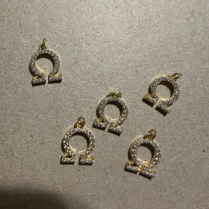 2 Gold pave Omega charms.