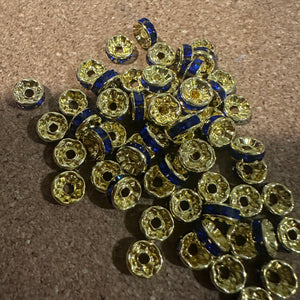 50 blue and gold rondelle spacers.