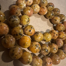 Load image into Gallery viewer, Orange and black beads.