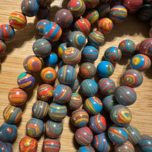 Load image into Gallery viewer, Blue and red swirl beads.