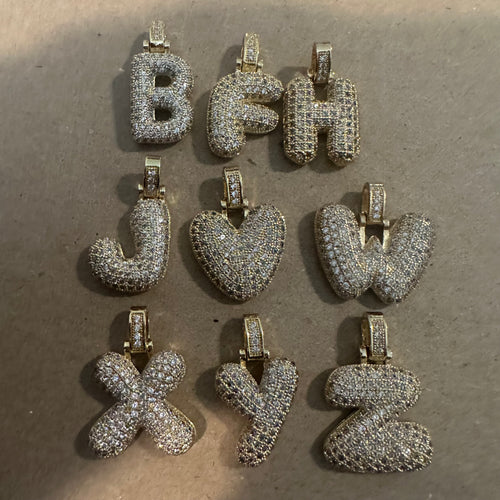 Gold pave letter charm.