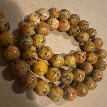 Load image into Gallery viewer, Orange and black beads.