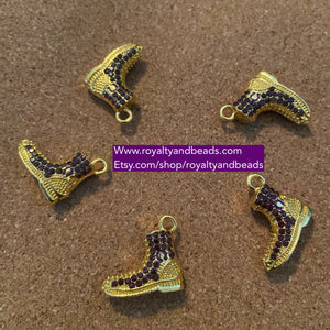 Purple and gold Omega boot charm.